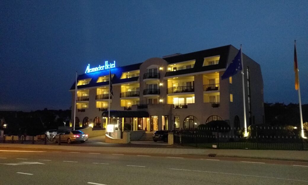 The hotel sign lights up in this evening view of the Alexander hotel in Noordwijk, venue of the CoSI conference.